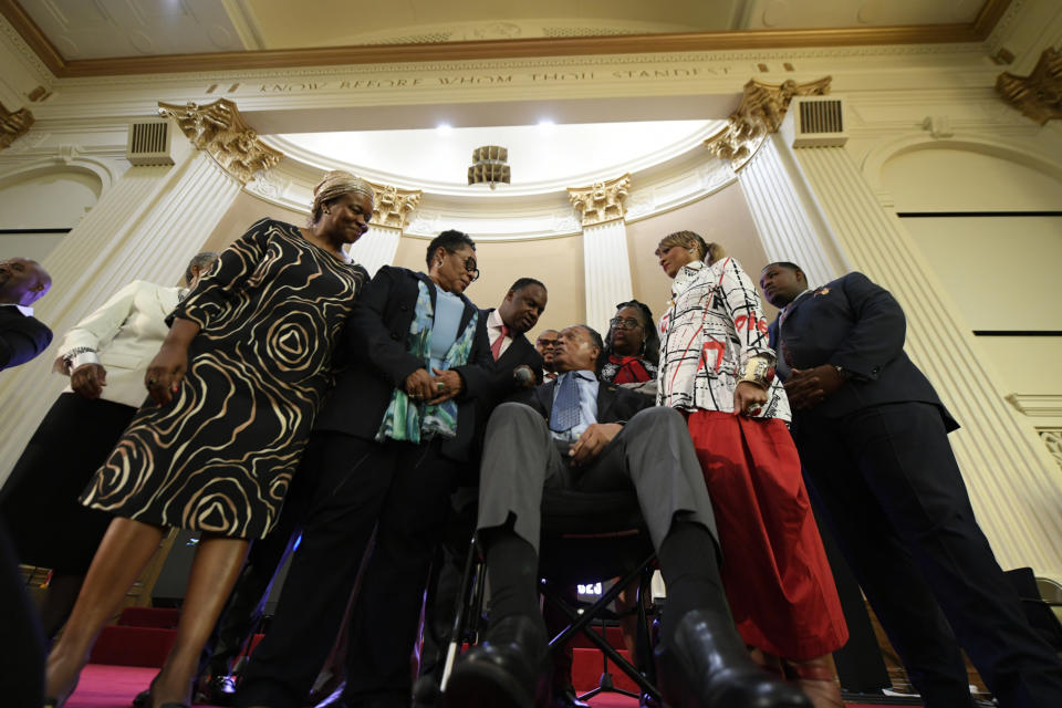 Rev. Jesse Jackson, center, talks with his son U.S. Rep. Jonathan Jackson D-Ill., before announcing that he is stepping down as president of the Rainbow PUSH Coalition Saturday, July 15, 2023, in Chicago. (AP Photo/Paul Beaty)