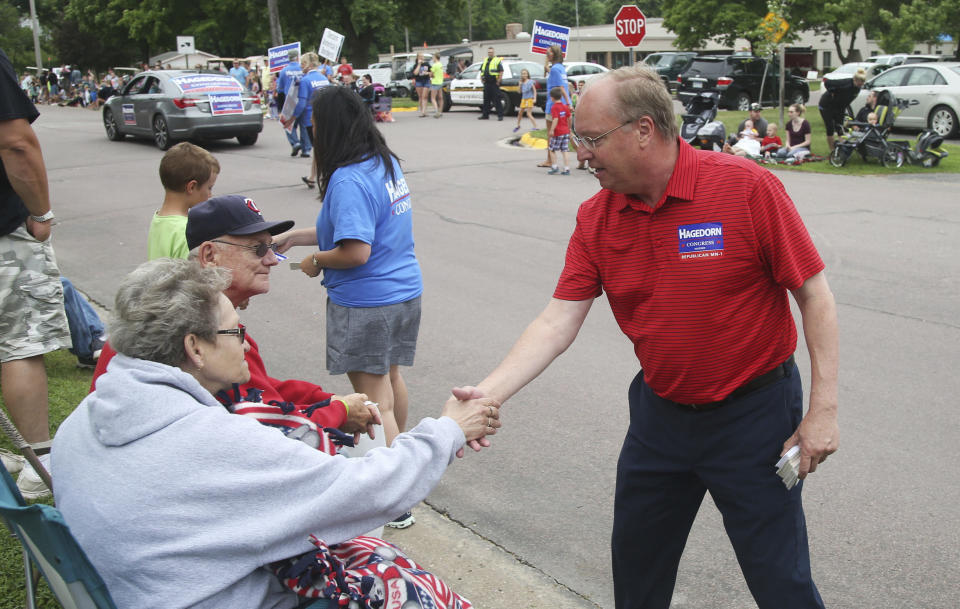 In this June 10, 2018 photo, Minnesota 1st District congressional candidate Jim Hagedorn works a parade in Waterville, Minn. Waterville's 54th annual Bullhead Days parade included Republican Hagedorn and Democrat Dan Feehan, candidates who came to shake as many hands as they could in the open seat race which promises to be one of the most closely watched races in the country. (AP Photo/Jim Mone)