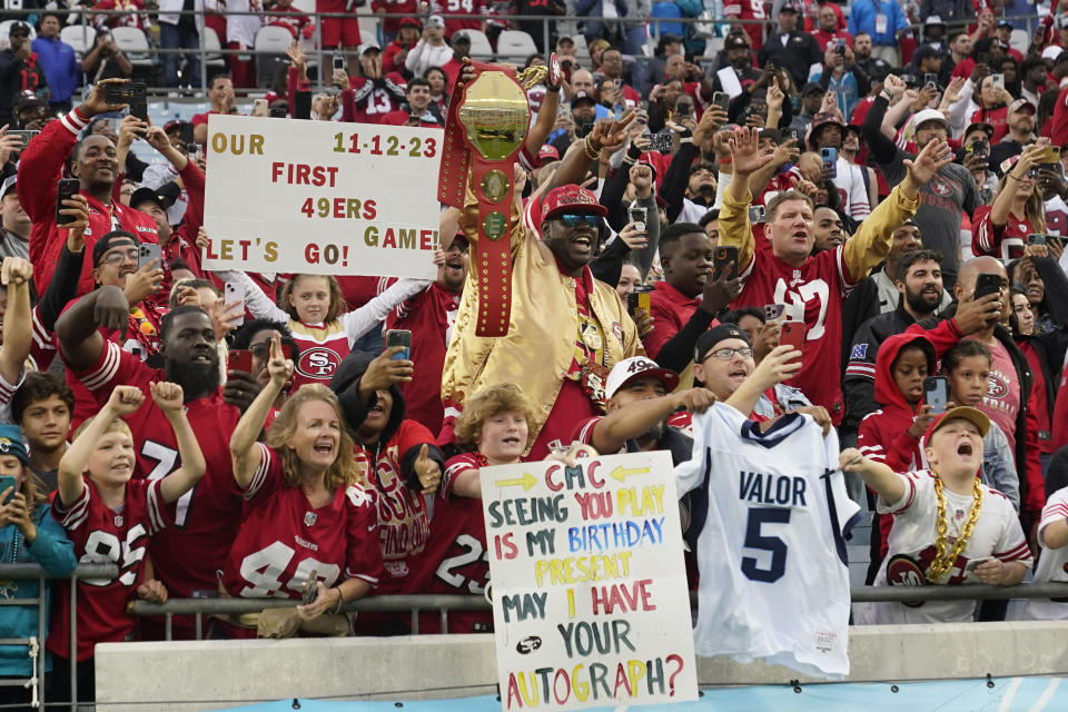 San Francisco 49ers fans cheer during the second half of an NFL football game between the Jacksonville Jaguars and the San Francisco 49ers, Sunday, Nov. 12, 2023, in Jacksonville, Fla. (AP Photo/John Raoux)