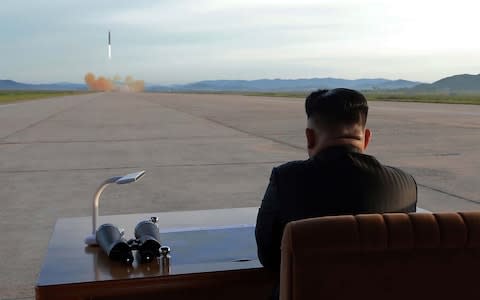 North Korean leader Kim Jong-un inspects a launching drill of the medium-and-long range strategic ballistic rocket Hwasong-12 at an undisclosed location in September - Credit: AFP