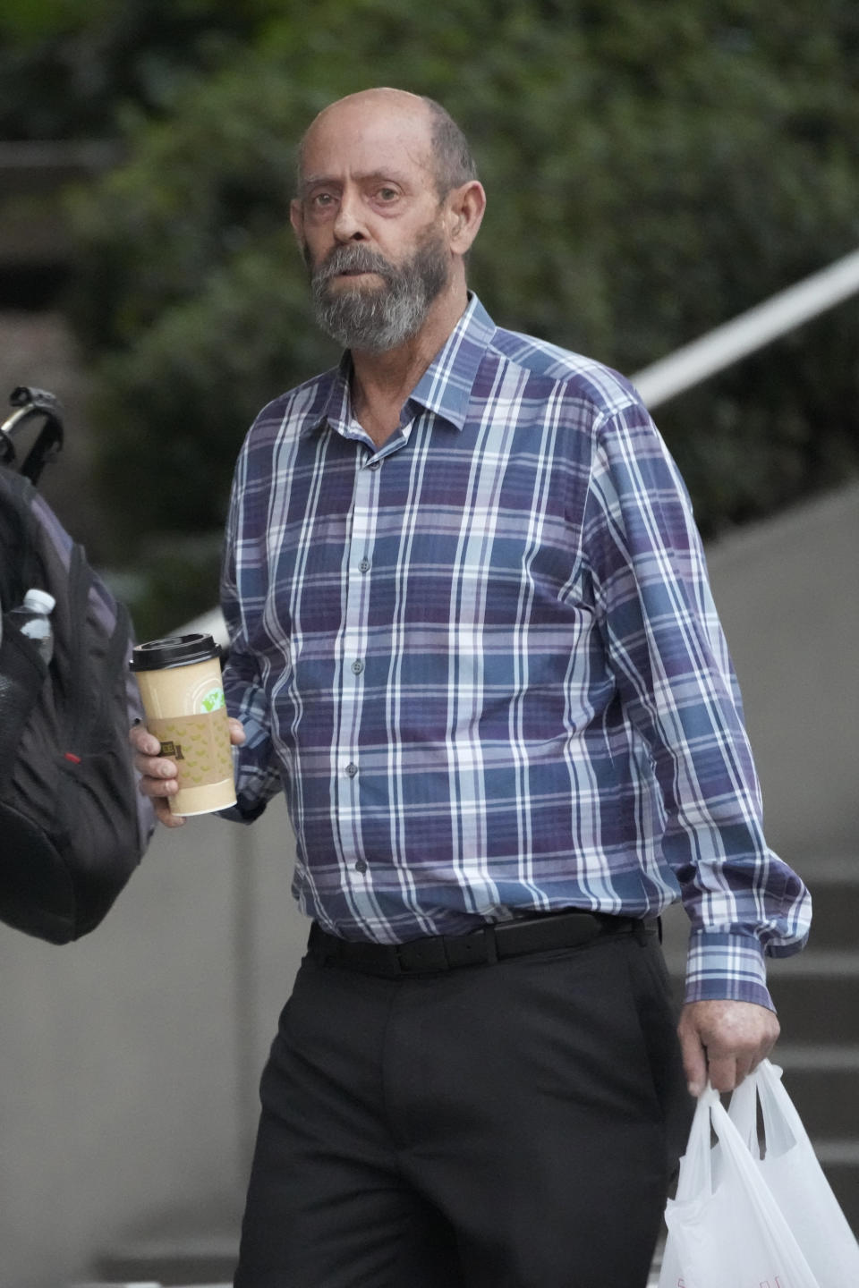 Defendant, Conception's captain Jerry Boylan, right, arrives in federal court in Los Angeles, Wednesday, Oct. 25, 2023. Federal prosecutors are seeking justice for 34 people killed in a fire aboard a scuba dive boat called the Conception in 2019. The trial against Boylan began Tuesday with jury selection. Boylan has pleaded not guilty to one count of misconduct or neglect of ship officer. (AP Photo/Damian Dovarganes)