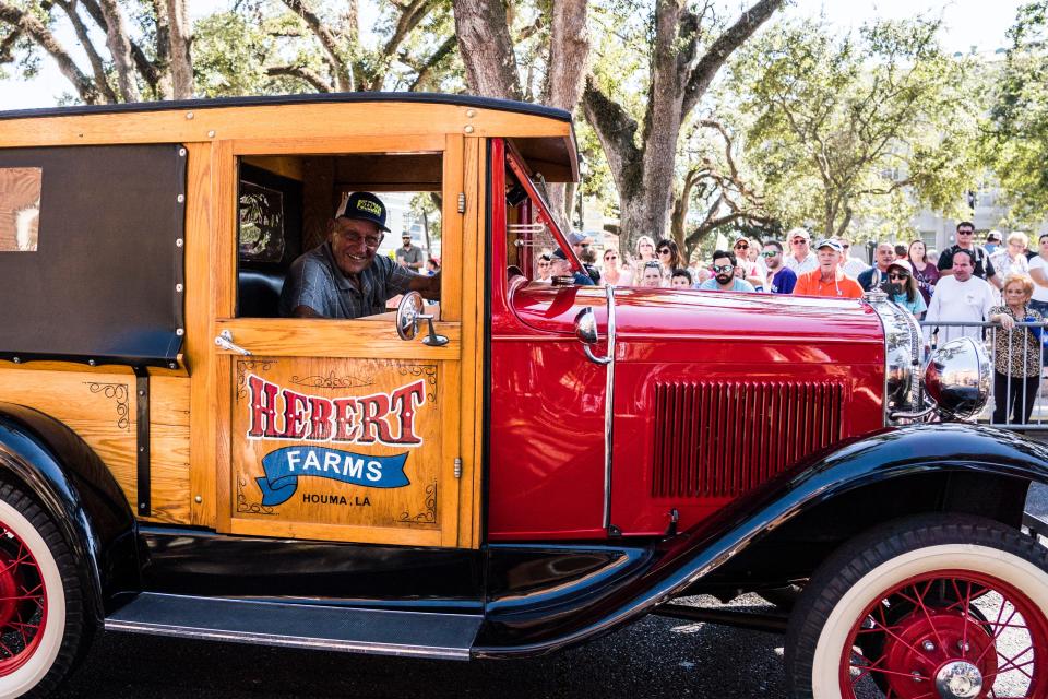 One of several antique cars in the parade heads up Main Street.