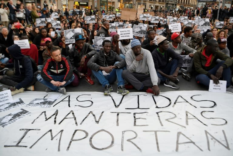 Protesters in Barcelona with a banner reading "Street vendors' lives matter"