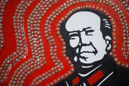 Badges of late Chinese Chairman Mao Zedong decorate an image of Mao at Jianchuan Museum Cluster in Anren, Sichuan Province, China, May 13, 2016. REUTERS/Kim Kyung-Hoon