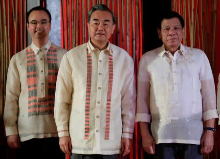 REFILE - ADDING NAME Philippine President Rodrigo Duterte with Chinese Foreign Minister Wang Yi and Secretary of Foreign Affairs Alan Peter Cayetano during a courtesy call for the 50th ASEAN Foreign Ministers’ Meeting at the Philippine International Convention Center in Pasay city, metro Manila, Philippines August 8, 2017. REUTERS/Romeo Ranoco