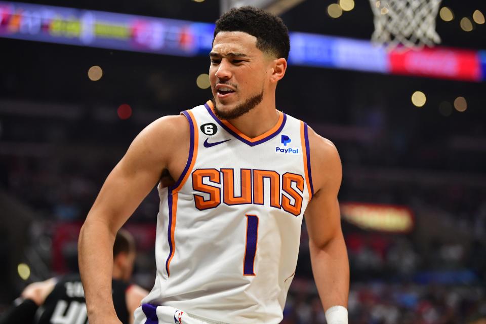 Phoenix Suns guard Devin Booker (1) reacts after colliding with Los Angeles Clippers guard Russell Westbrook (0) during the first half in game four of the 2023 NBA playoffs at Crypto.com Arena on April 22, 2023.