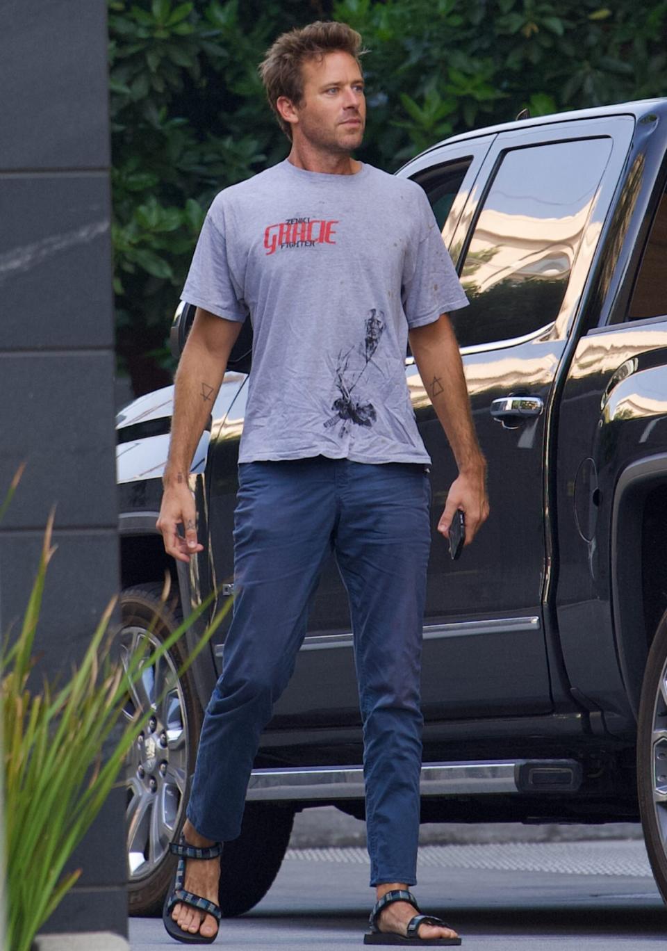 EXCLUSIVE: Armie Hammer wears a ripped and stained t-shirt as he emerges following lawsuit from American Express over $67K in unpaid charges.