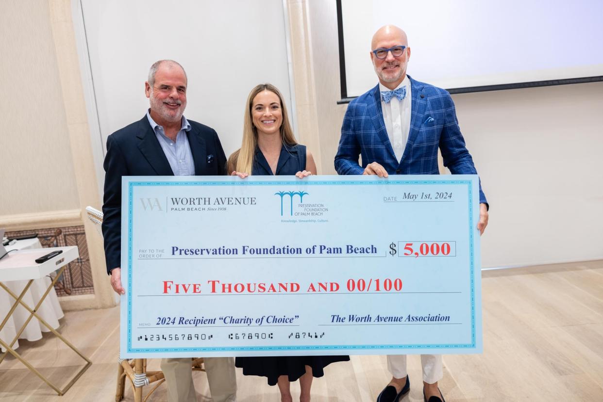 Left to right: Worth Avenue Association President Frank Steinhart, Preservation Foundation of Palm Beach CEO Amanda Skier, and Worth Avenue Association historian Rick Rose pose with a $5,000 check for the foundation during an association meeting May 1 at The Colony.