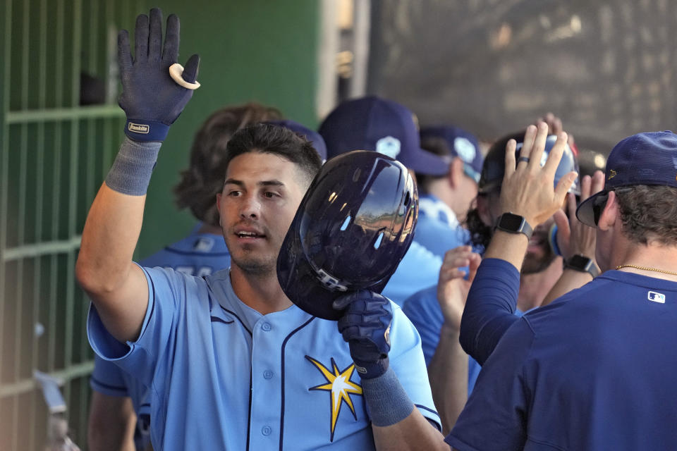 Tampa Bay Rays' Ruben Cardenas high fives teammates in the dugout after his three-run home run off Philadelphia Phillies' James McArthur during the sixth inning of a spring training baseball game Tuesday, March 7, 2023, in Clearwater, Fla. (AP Photo/Chris O'Meara)