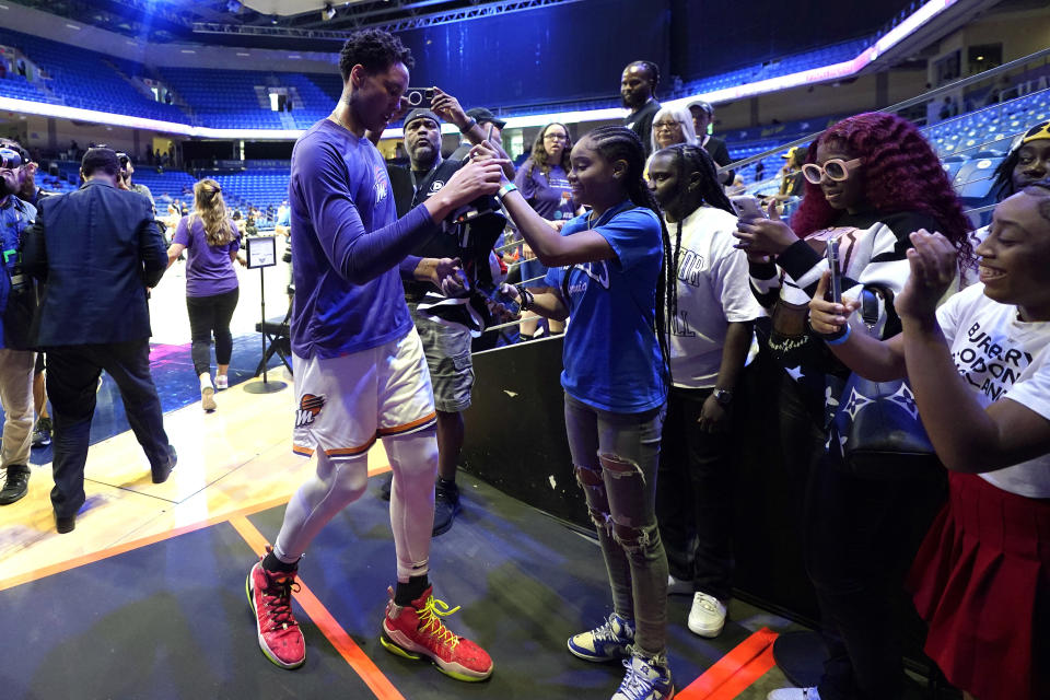 Phoenix Mercury's Brittney Griner, left, talks with fans after preparing for the team's WNBA basketball game against the Dallas Wings, Wednesday, June 7, 2023, in Arlington, Texas. (AP Photo/Tony Gutierrez)