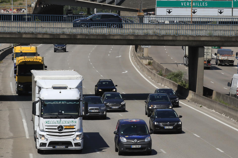 Cars drive on the motorway leading to Paris, Tuesday, May 26, 2020 in Villacoublay, west of Paris. French President Emmanuel Macron is set to unveil on Tuesday new measures to rescue the country's car industry, which has been hammered by the virus lockdown and the resulting recession. The issue is politically sensitive, since France is proud of its auto industry, which employs 400,000 people in the country and is a big part of its manufacturing sector. (AP Photo/Michel Euler)