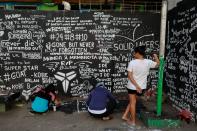 Fans write messages in memory of Kobe Bryant after he and his daughter Gianna died in a helicopter crash, on the basketball court of a housing tenement in Taguig City, Metro Manila