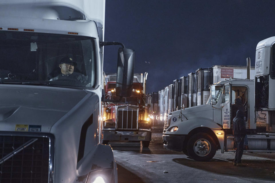 Drivers position their trucks on the loading docks inside the Hunts Point Produce Market on Tuesday, Nov. 22, 2022, in the Bronx borough of New York. Hunts Point's wholesalers distribute 2.5 billion pounds of produce a year, with about 30 million pounds having moved on Tuesday alone. The produce ends up at places like Whole Foods, high-end grocers and specialty markets, as well smaller mom-and-pop outlets. Thanksgiving is especially busy time of year because the quintessentially American feast is universally celebrated across the United States. (AP Photo/Andres Kudacki)