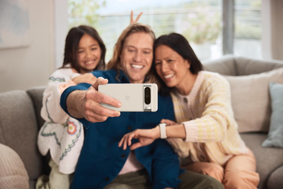 Three people take a selfie with a Google Pixel 8 Pro.