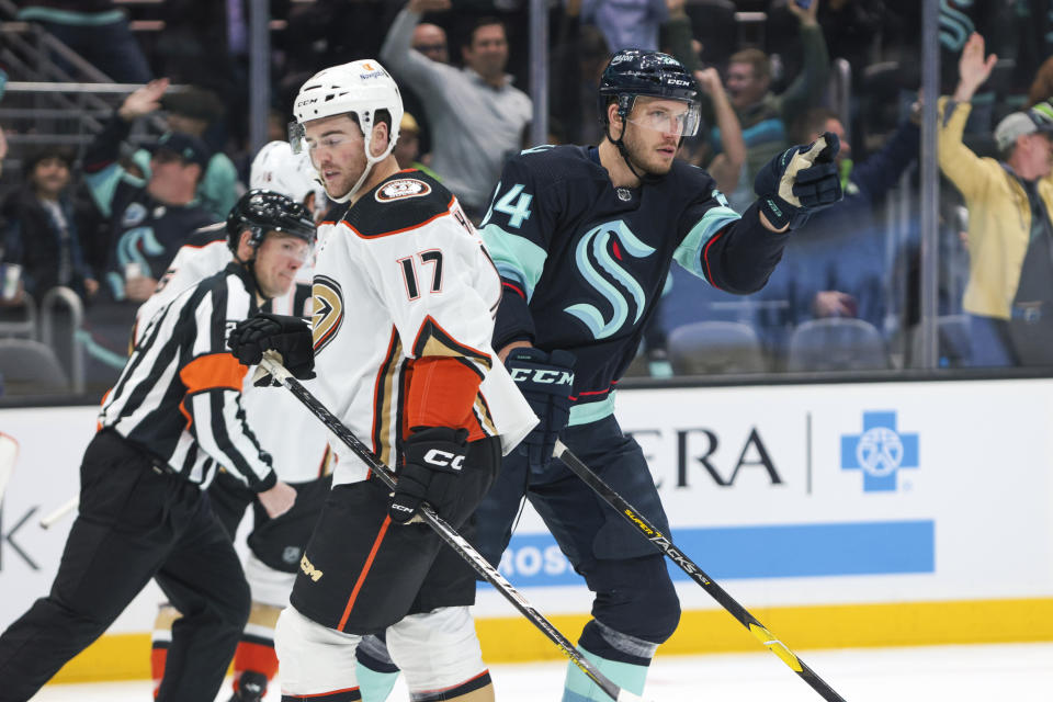 Seattle Kraken defenseman Jamie Oleksiak, right, celebrates his goal as Anaheim Ducks defenseman Scott Harrington looks on during the first period of an NHL hockey game Tuesday, March 7, 2023, in Seattle. (AP Photo/Jason Redmond)