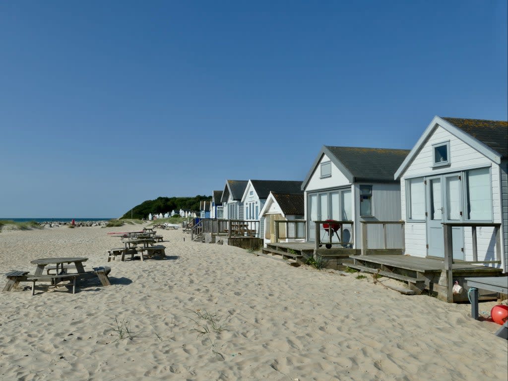 Beach huts along the Mudeford sandbanks  (Geoffrey Swaine/Shutterstock)