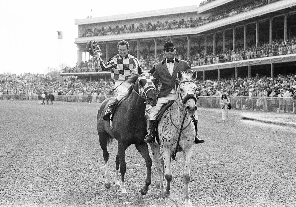FILE - Jockey Ron Turcotte is led to the Winner's Circle at Churchill Downs in Louisville, Kentucky, May 5, 1973, after Turcotte rode Secretariat to a record win in the 99th Kentucky Derby. (AP Photo/File)