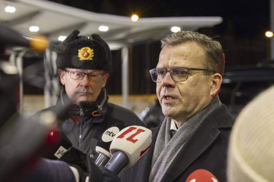 Finland's Prime Minister Petteri Orpo speaks at a press briefing with Chief of the Finnish Border Guard, Lieutenant General Pasi Kostamovaara at left, during a visit to the Vartius border crossing station in Kuhmo, eastern Finland, Monday Nov. 20, 2023. The prime minister on Monday said the country may need to take further actions on its border with Russia after closing four border crossings in an attempt to stem a recent increase in asylum-seekers. (Hannu Huttu/Lehtikuva via AP)