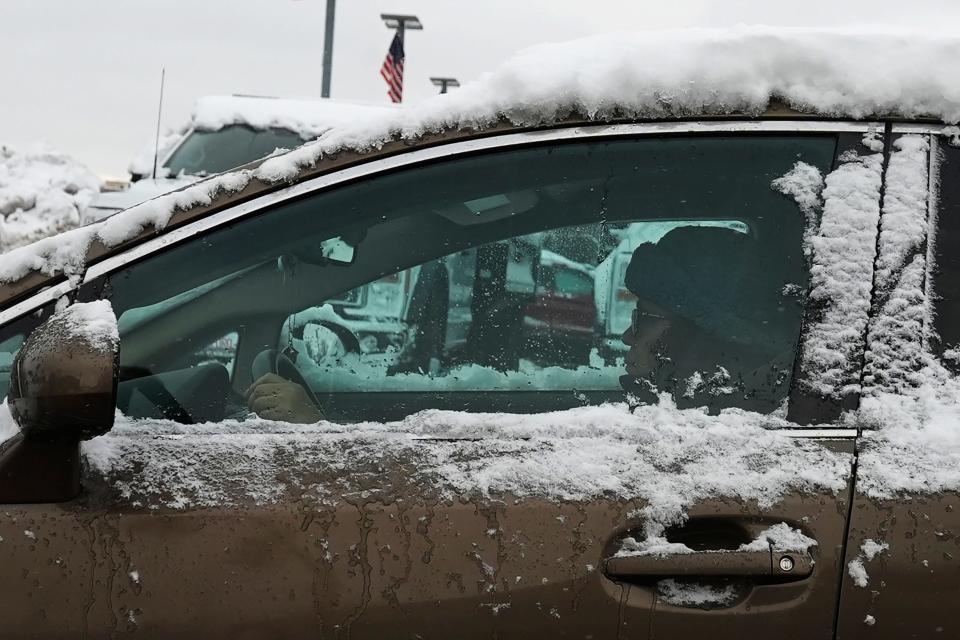 A driver moves along a snow-covered street in Buffalo Grove, Ill., Saturday, Jan. 13, 2024. (AP Photo/Nam Y. Huh) ORG XMIT: OTKNH102