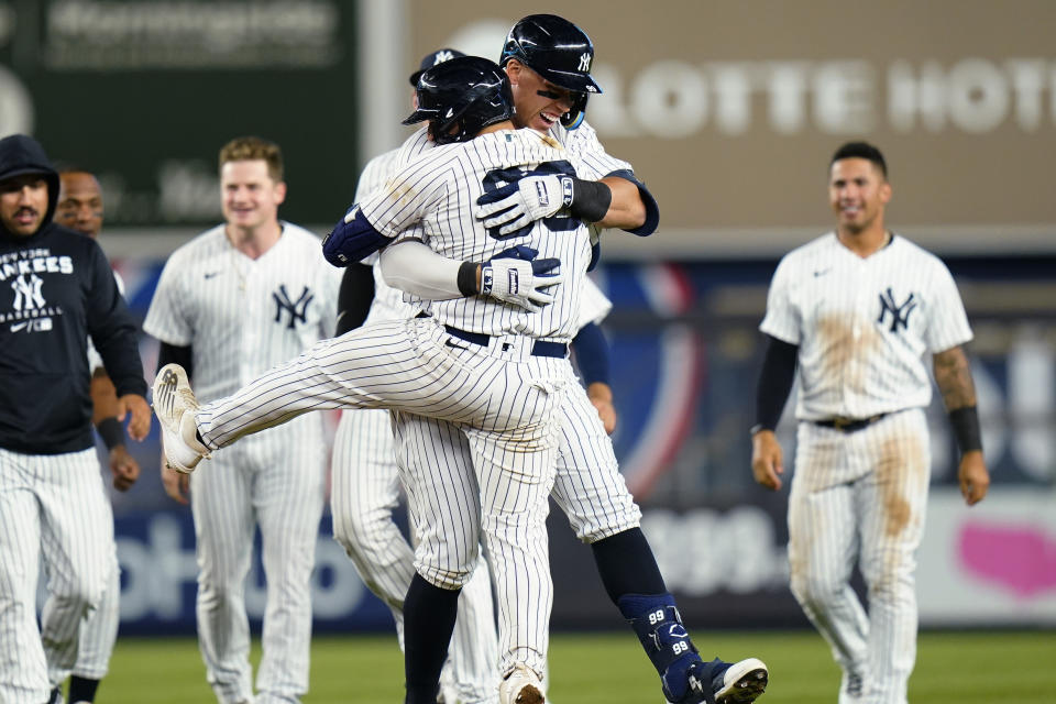 New York Yankees' Aaron Judge hugs Jose Trevino, front, after Trevino hit a single to drive in the winning run during the 11th inning of the team's baseball game against the Baltimore Orioles on Tuesday, May 24, 2022, in New York. (AP Photo/Frank Franklin II)
