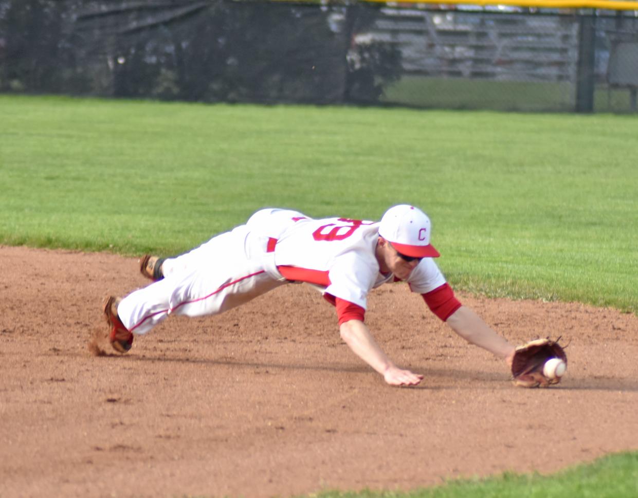 Coldwater second baseman Ethan Parker dives for a grounder in the hole Tuesday versus Marshall