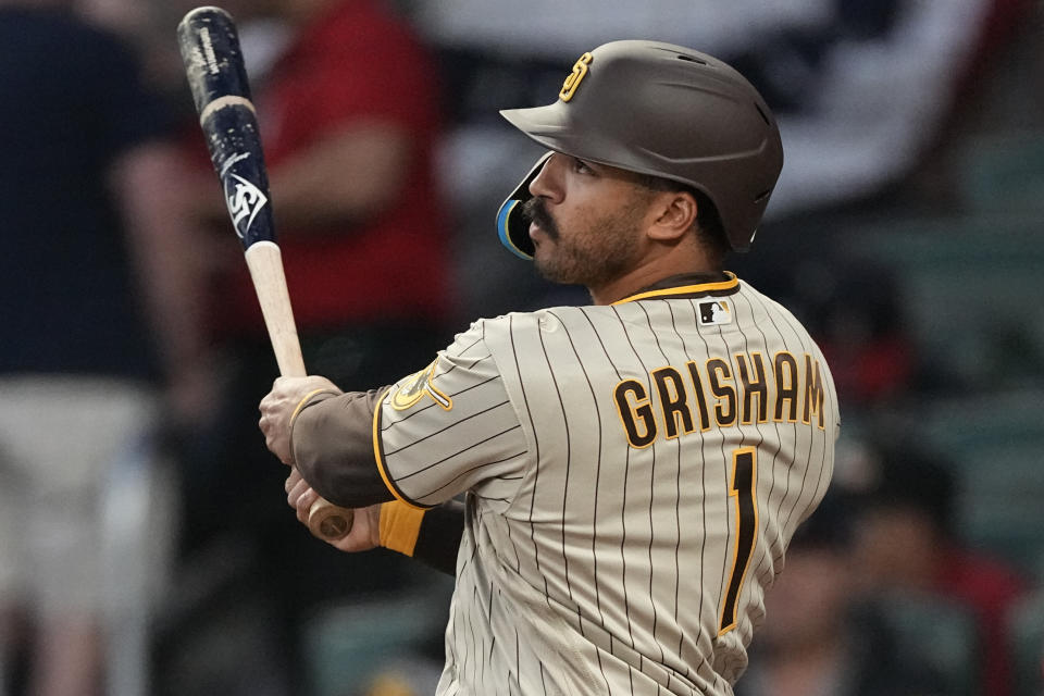 San Diego Padres' Trent Grisham follows through on a solo home run in the fourth inning of a baseball game against the Atlanta Braves, Sunday, April 9, 2023, in Atlanta. (AP Photo/John Bazemore)