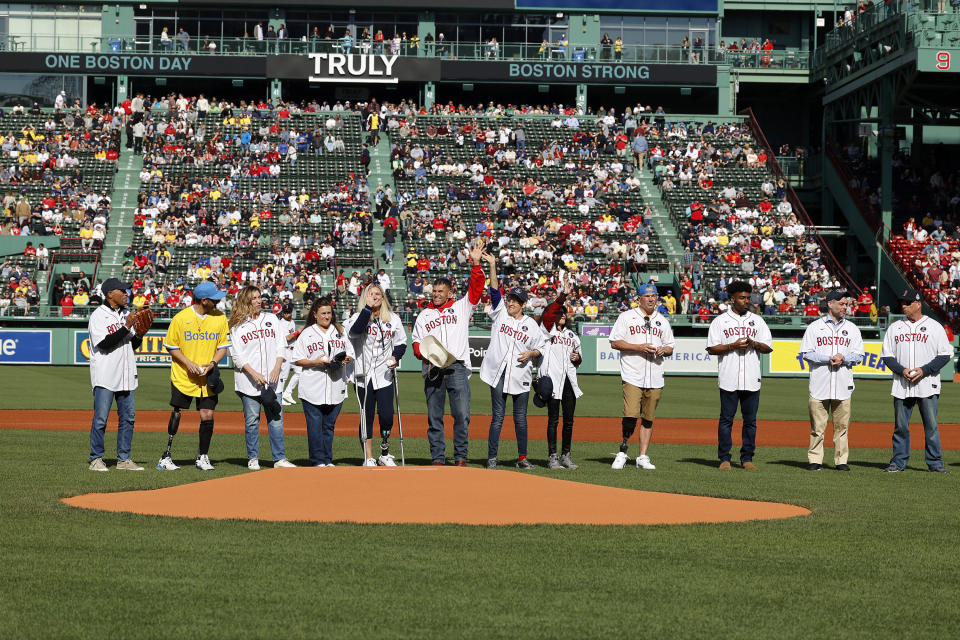 Former Massachusetts governor Deval Patrick, left, joins Boston Marathon bombing survivors during a ceremony before a baseball game between the Boston Red Sox and the Los Angeles Angels at Fenway Park, Saturday, April 15, 2023, in Boston. (AP Photo/Mary Schwalm)