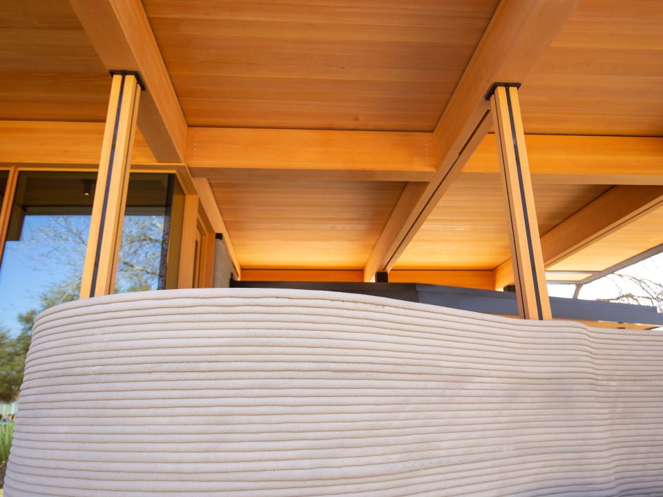 Icon's over 2,000-square-foot House Zero in Austin. There's a printed exterior wall under wooden roof features.