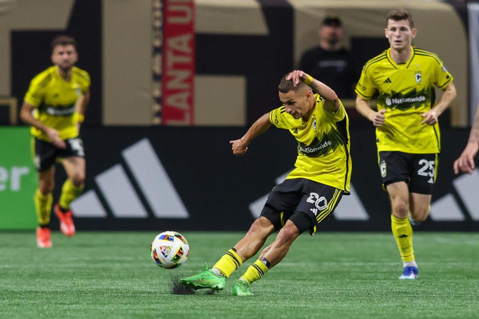 Jul 20, 2024; Atlanta, Georgia, USA; Columbus Crew midfielder Alexandru Matan (20) kicks the ball against the Atlanta United in the second half at Mercedes-Benz Stadium. Mandatory Credit: Brett Davis-USA TODAY Sports