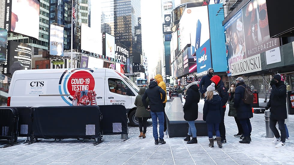 People wait in line to be tested for COVID-19 at a mobile testing site parked Times Square in New York City on Tuesday, January 4, 2022. 