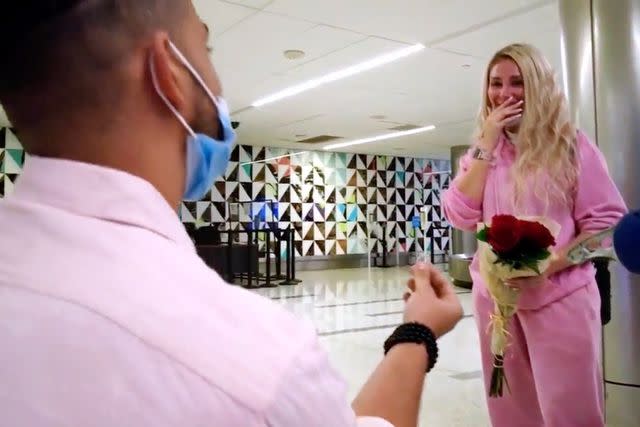 <p>TLC</p> Rob pops the question to Sophie at a Los Angeles airport.