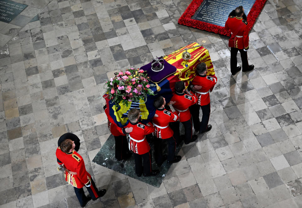 LONDON, ENGLAND - SEPTEMBER 19: The coffin of Queen Elizabeth II with the Imperial State Crown resting on top is carried by the Bearer Party into Westminster Abbey during the State Funeral of Queen Elizabeth II on September 19, 2022 in London, England. Elizabeth Alexandra Mary Windsor was born in Bruton Street, Mayfair, London on 21 April 1926. She married Prince Philip in 1947 and ascended the throne of the United Kingdom and Commonwealth on 6 February 1952 after the death of her Father, King George VI. Queen Elizabeth II died at Balmoral Castle in Scotland on September 8, 2022, and is succeeded by her eldest son, King Charles III. (Photo by Gareth Cattermole/Getty Images)