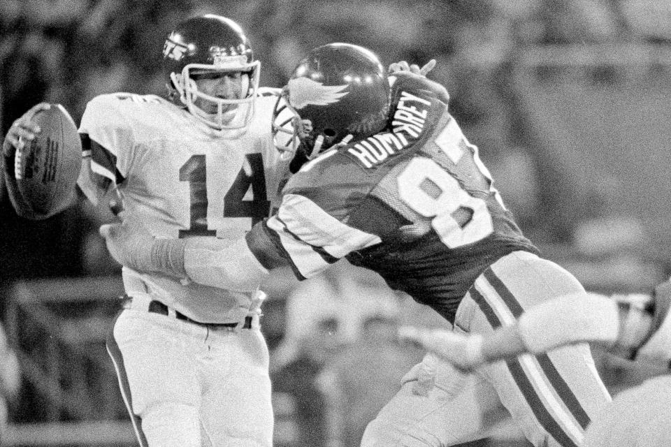 FILE - Philadelphia Eagles' Claude Humphrey (87) grabs New York Jets quarterback Richard Todd (14) and pulls him down for an 11-yard loss during an exhibition NFL football game in Philadelphia, on Aug. 15, 1980. Humphrey, a Pro Football Hall of Famer Claude and one of the NFL's most fearsome pass rushers during the 1970s, died unexpectedly in Atlanta on Friday night, Dec. 3, 2021, according to the Hall of Fame, which was informed of his death by his daughter. He was 77. (AP Photo/Clem Murray, File)