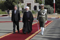 In this photo released by official website of the office of the Iranian Presidency, President Hassan Rouhani, center, leaves for New York to attend the United Nations General Assembly, at Mehrabad Airport in Tehran, Iran, Sunday, Sept. 23, 2018. On Saturday, the same day Arab separatists killed at least 25 people in an attack targeting a military parade in Iran, Rudy Giuliani, President Donald Trump’s lawyer, declared that the government would be toppled. Iran fears that America and its Gulf Arab allies are plotting to tear the Islamic Republic apart. (Iranian Presidency Office via AP)