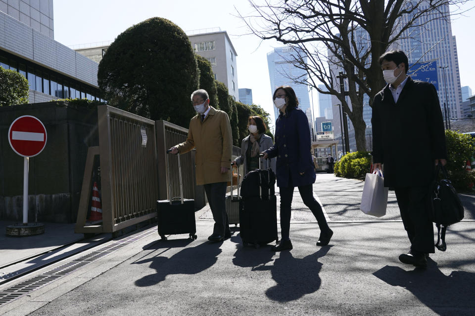 Lawyers of a Japanese air force serviceperson who filed a lawsuit against the government, walk to enter Tokyo District Court Monday, Feb. 27, 2023, in Tokyo. The plaintiff, who was only identified as a current member of the Air Self Defense Force, filed a lawsuit against the government on Monday, saying it failed to protect her from sexual harassment from a male colleague and then systematically covered up the problem for more than a decade.(AP Photo/Eugene Hoshiko)