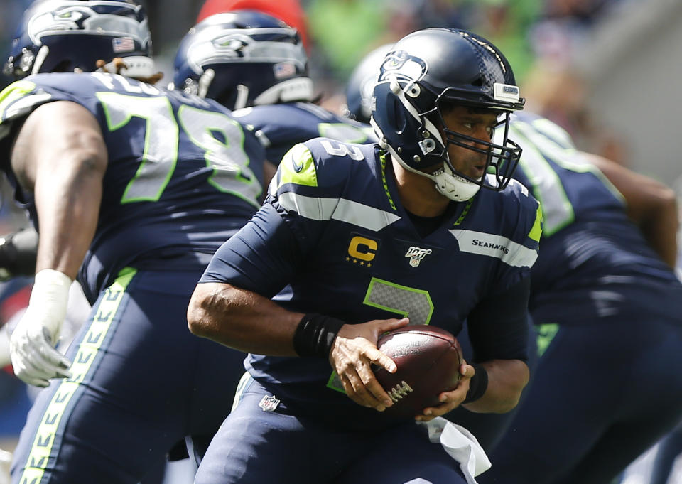 Russell Wilson #3 of the Seattle Seahawks looks to hand off the ball against the Cincinnati Bengals in the first quarter at CenturyLink Field on September 8, 2019 in Seattle, Washington. (Photo by Lindsey Wasson/Getty Images)