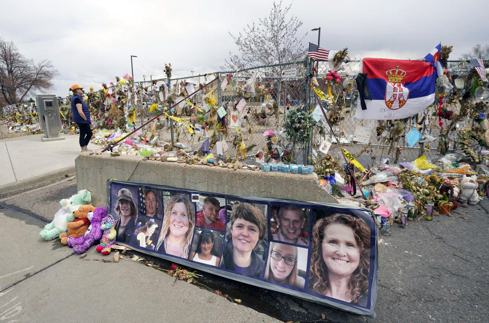 FILE - Pictures of the 10 victims of a mass shooting in a King Soopers grocery store are posted on a cement barrier outside the supermarket in Boulder, Colo., on April 23, 2021. Prosecutors said Wednesday, Aug. 23, 2023, that Ahmad Al Aliwi Alissa, accused of killing 10 people at the Boulder supermarket in 2021, is competent for trial. (AP Photo/David Zalubowski, File)