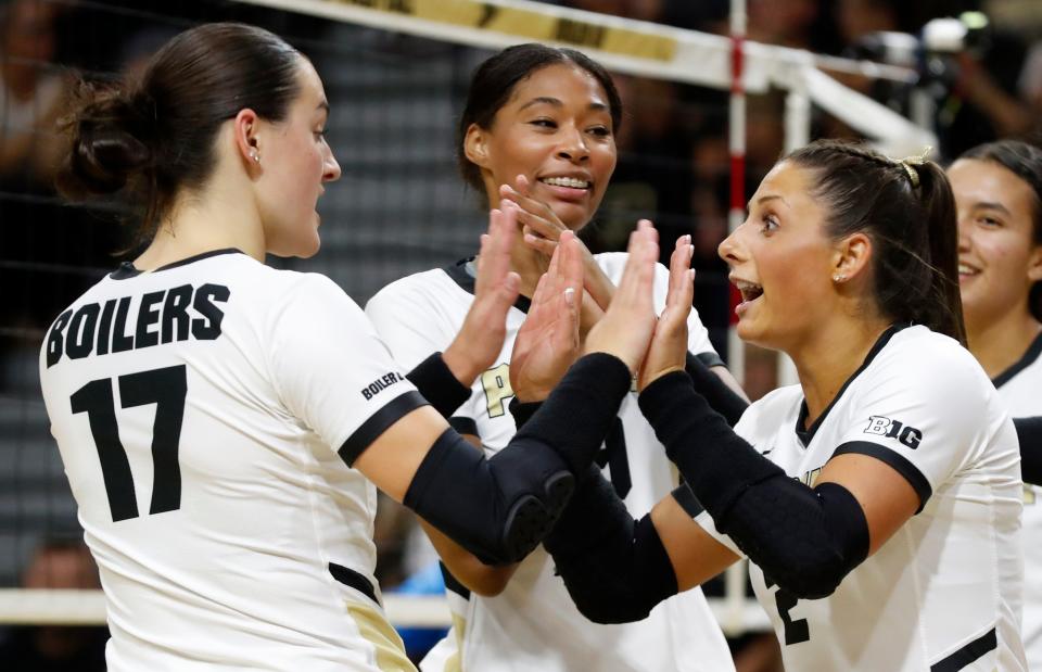 Purdue Boilermakers Evan Hudson (17) and Purdue Boilermakers Chloe Chicoine (2) high-five during the NCAA women’s volleyball match against the Central Florida Knights, Thursday, Sept. 14, 2023, at Holloway Gymnasium in West Lafayette, Ind.