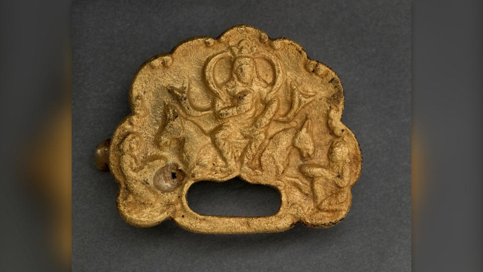 Some of the details on the best-preserved plaque have melted, but it shows a Göktürk khagan seated on a throne that represents two horses, flanked by kneeling servants.