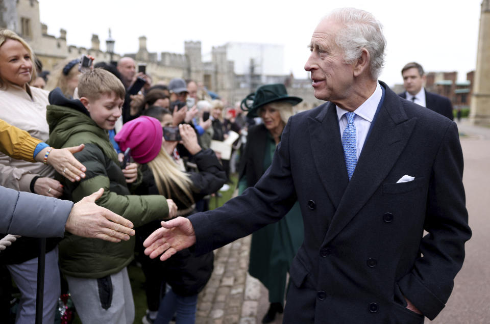 Britain's King Charles III and Queen Camilla greet people after attending the Easter Matins Service at St. George's Chapel, Windsor Castle, England, Sunday, March 31, 2024. (Hollie Adams/Pool Photo via AP)