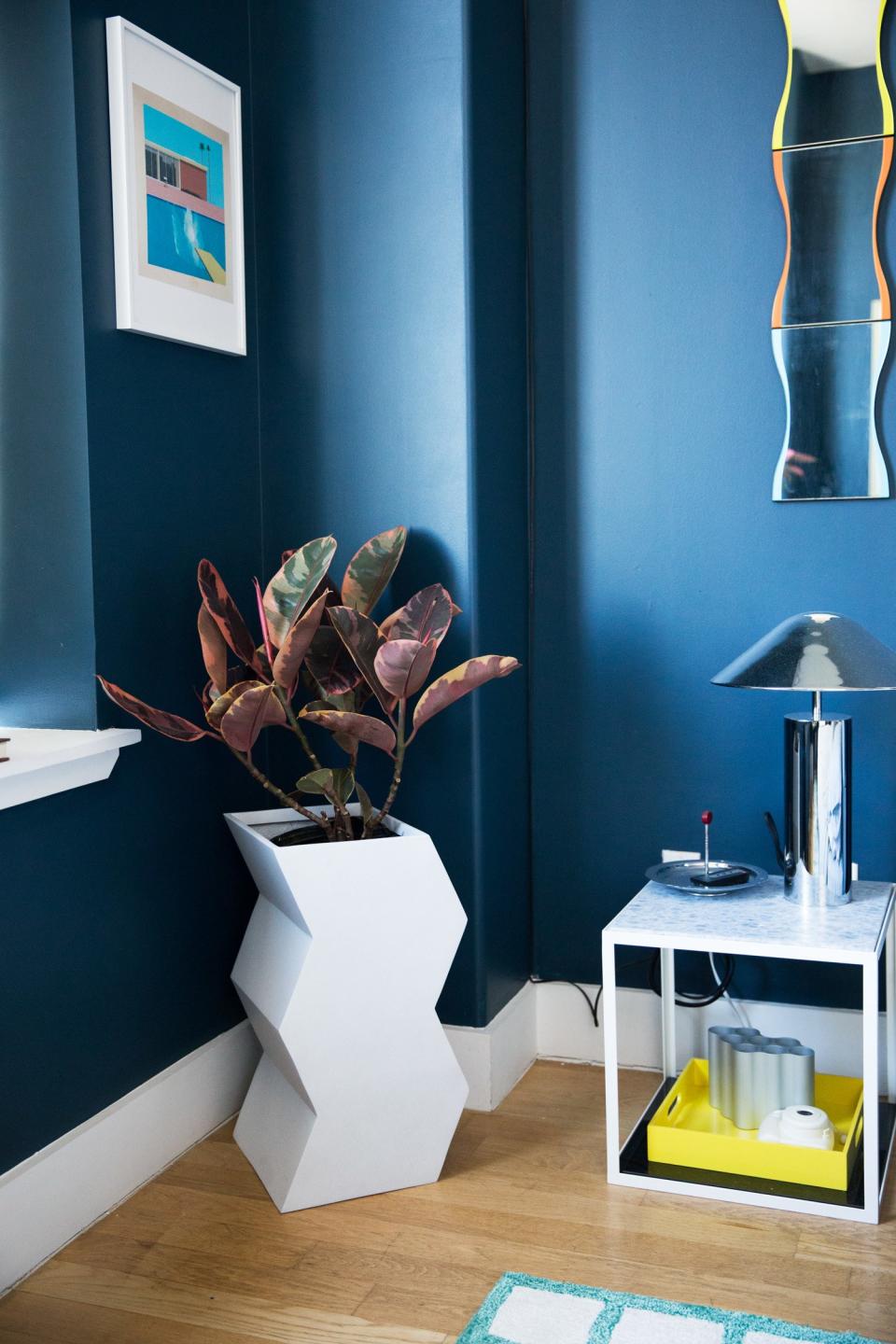 She goes on, "I definitely love a strong color story, but I don’t like it to look too perfect. Keeping the navy walls made it feel like us rather than cookie cutter." (The Zig Zag planter is one of Pieces' latest creations.)