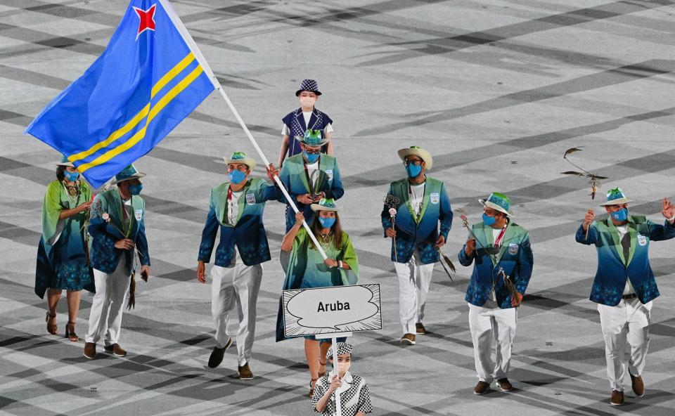 The athletes wore multi-colored blazers and light pants or dark skirts