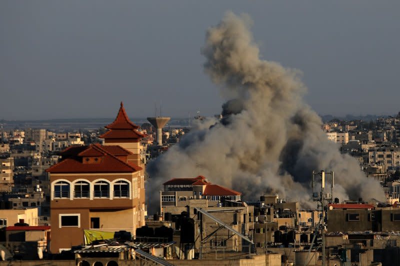 Smoke rises above buildings in the southern Gaza Strip after an Israeli strike on Wednesday. Photo by Ismael Mohamad/UPI