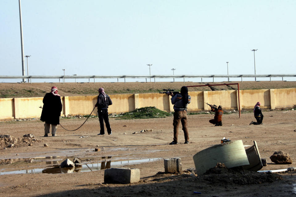 Gunmen patrol in Fallujah, 40 miles (65 kilometers) west of Baghdad, Iraq, Sunday, Jan. 12, 2014. Iraqi forces have yet to militarily try to reassert control over Fallujah, which remains in the hands of the militants and tribal gunmen opposed to the central government. Militants and tribal fighters also control part of the provincial capital, Ramadi. Sporadic clashes there and in surrounding areas continue to take place. (AP Photo)