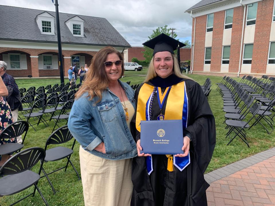 Brevard College's first Graduate Student, Emily White graduating with an Emergency Management Master's Degree, pictured with her mother, Stacey Moore White.