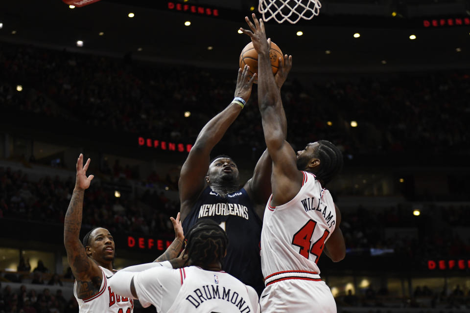 New Orleans Pelicans' Zion Williamson (1) goes up for a shot against Chicago Bulls' Patrick Williams (44), Andre Drummond (3) and DeMar DeRozan (11) during the second half of an NBA basketball game Saturday, Dec. 2, 2023, in Chicago. Chicago won 124-118. (AP Photo/Paul Beaty)