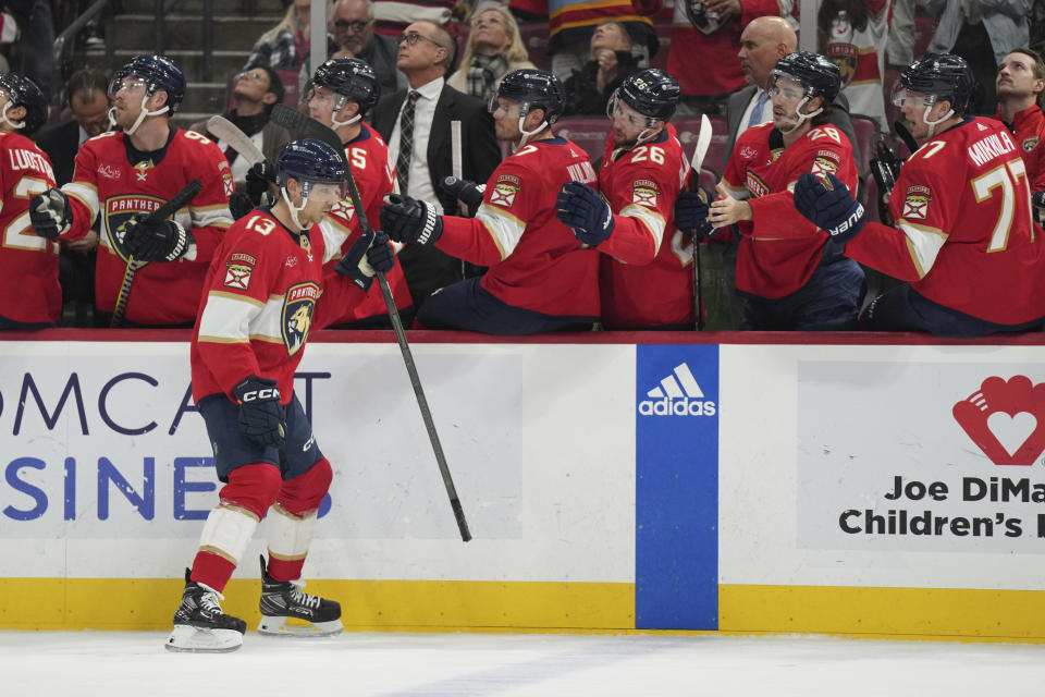 Florida Panthers center Sam Reinhart (13) celebrates a goal against the Chicago Blackhawks with teammates during the first period of an NHL hockey game Sunday, Nov. 12, 2023, in Sunrise, Fla. (AP Photo/Jim Rassol)