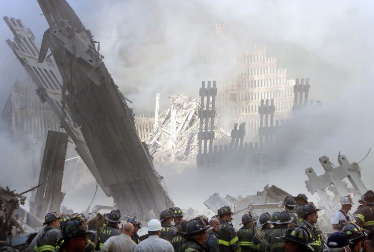 A group of firefighters stands near the destroyed World Trade Center, Sept. 11, 2001. (Photo: Shannon Stapleton/Reuters)