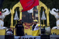 Protest leader Parit "Penguin" Chiwarak speaks during a rally while wearing an outfit of a yellow duck, which has become a good-humored symbol of resistance during anti-government rallies, outside the Siam Commercial Bank, a publicly-held company in which the Thai king is the biggest shareholder, Wednesday, Nov. 25, 2020, in Bangkok, Thailand. Thai authorities have escalated their legal battle against the students leading pro-democracy protests, charging 12 of them with violating a harsh law against defaming the monarchy. (AP Photo/Wason Wanichakorn)