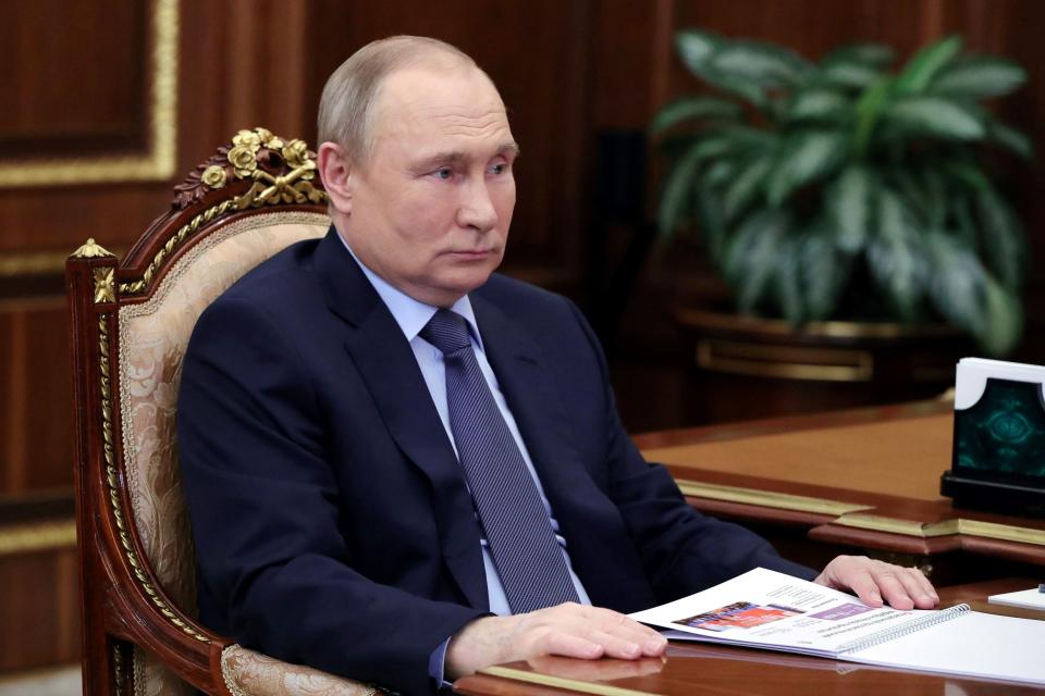 Russia's President Vladimir Putin listens during his meeting with 